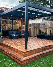 Modern wooden deck with pergola, outdoor seating, and decorative plants.